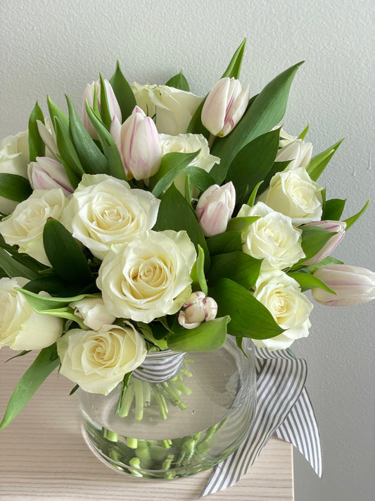 Mix of flowers in a clear vase